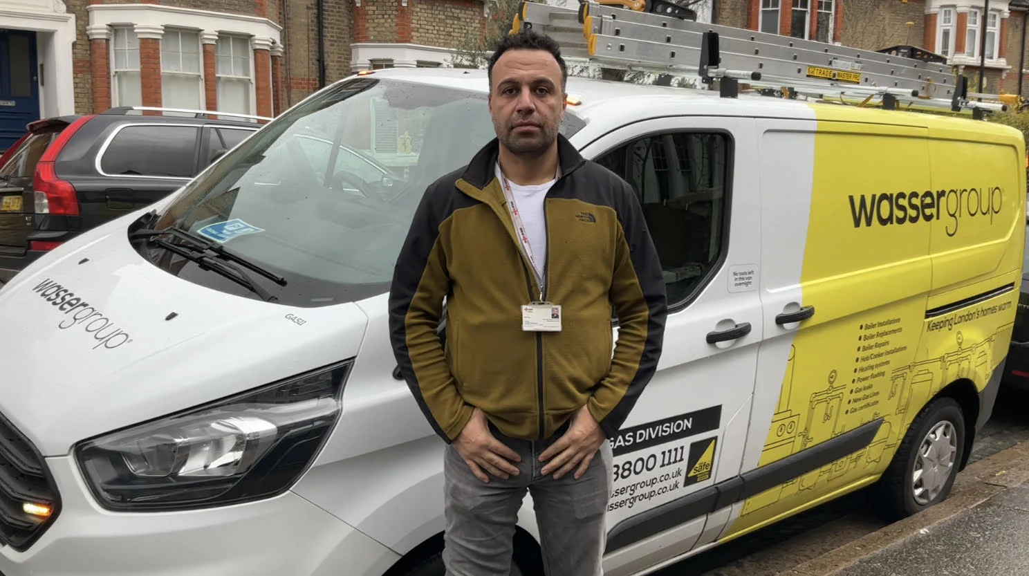 Wasser Group team member beside a branded service van